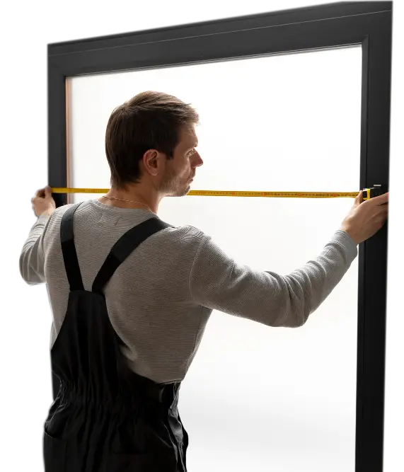 Professional installer measuring a window frame with a tape measure during installation preparation, highlighting precision workmanship, quality materials, and reliable Window Replacement Alpharetta services for accurate and efficient home upgrades.