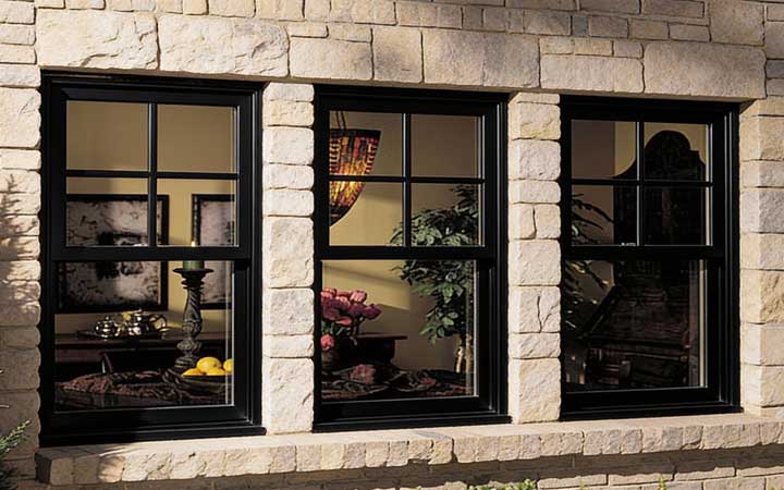 Home exterior featuring a white-framed window with red curtains next to a wooden entry door, showcasing clean siding, updated design, and professional Window Replacement Atlanta services for improved style and energy efficiency.
