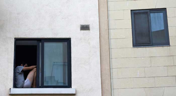 Minimalist building exterior with a blue-framed window featuring closed blinds, showcasing clean modern architecture, privacy, and professional Window Replacement Atlanta services for durability and energy efficiency.